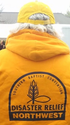 A NWBDR volunteer in the traditional gold shirt